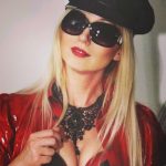 happy dominatrix wearing red and black latex